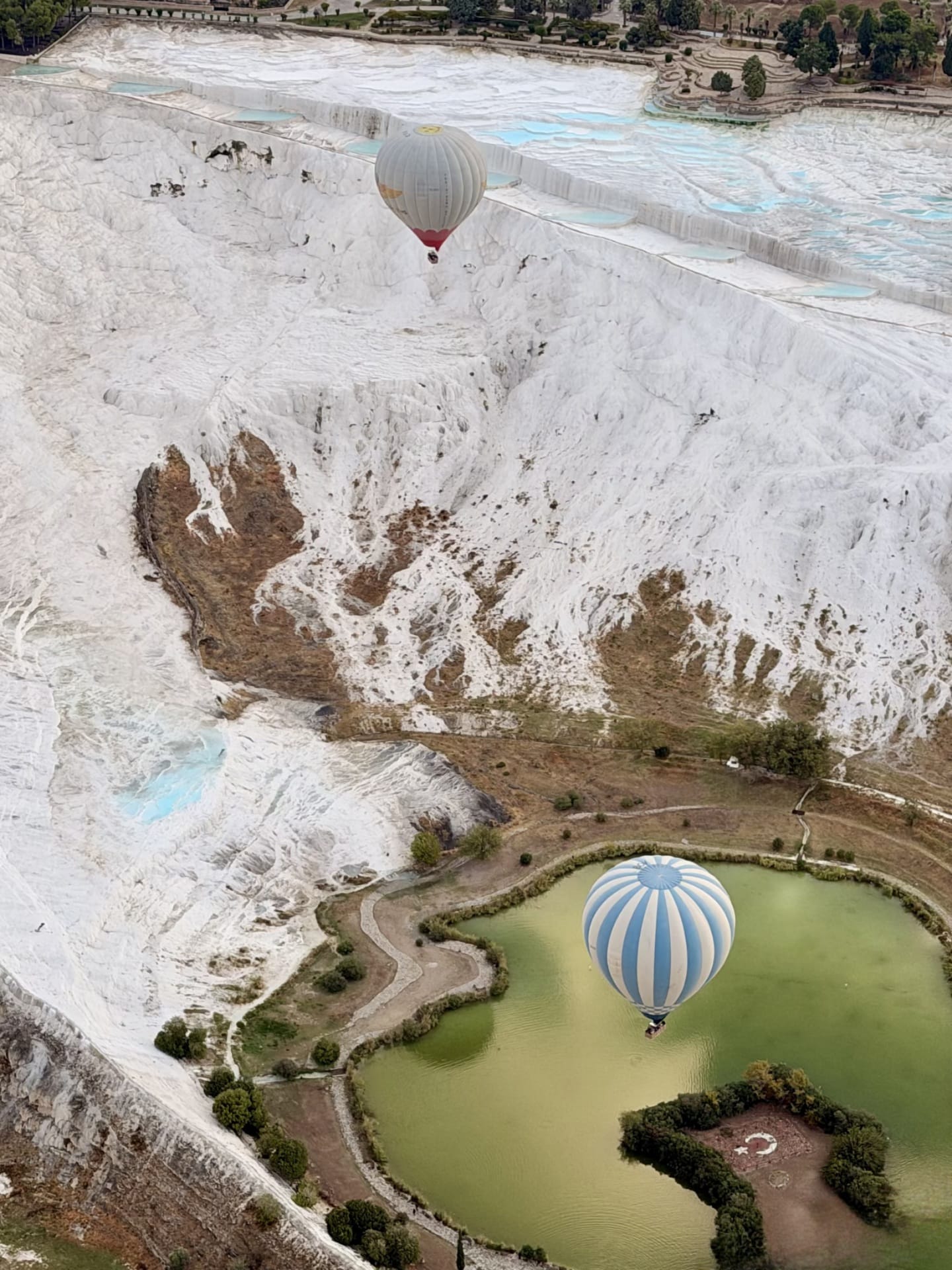 Aerial view of Pamukkale travertines with hot air balloons